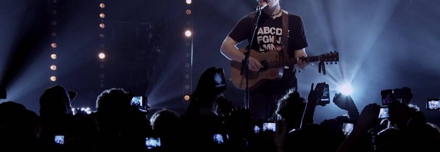 Singer-songwriter, Ed Sheeran, playing acoustic guitar live