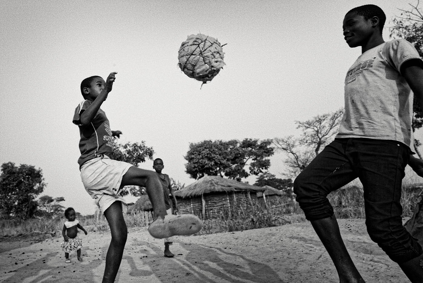 Two boys play football on a former minefield, which was cleared by MAG (Sean Sutton/MAG)