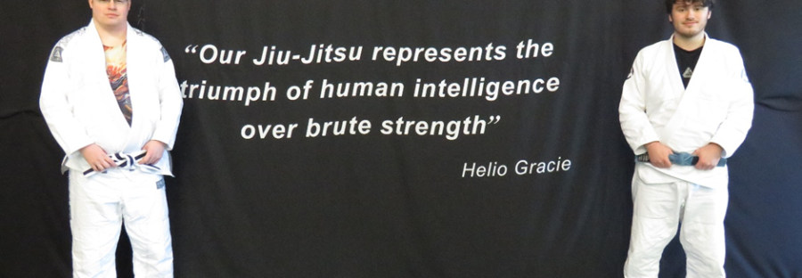 philip_left_and_james_right_at_the_centre_in_front_of_a_quote_from_the_founder_of_gracie_jiu_jitsu_displayed_inside_the_gracie_jiu_jitsu_tameside_centre