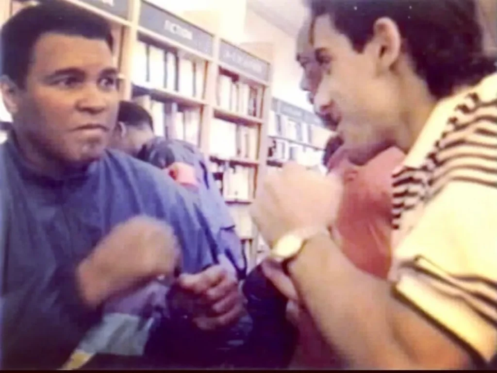 Paul Bhatti and Mohammed Ali play boxing at the Sherratt and Hughes book store in 1992 in St Anne's Square, Manchester 