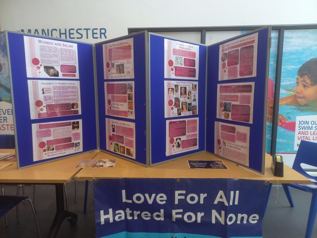 Blue information poster boards on a brown table with pink posters 