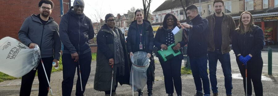 Moss Side residents meet up for spring clean holding bags and litter pickers