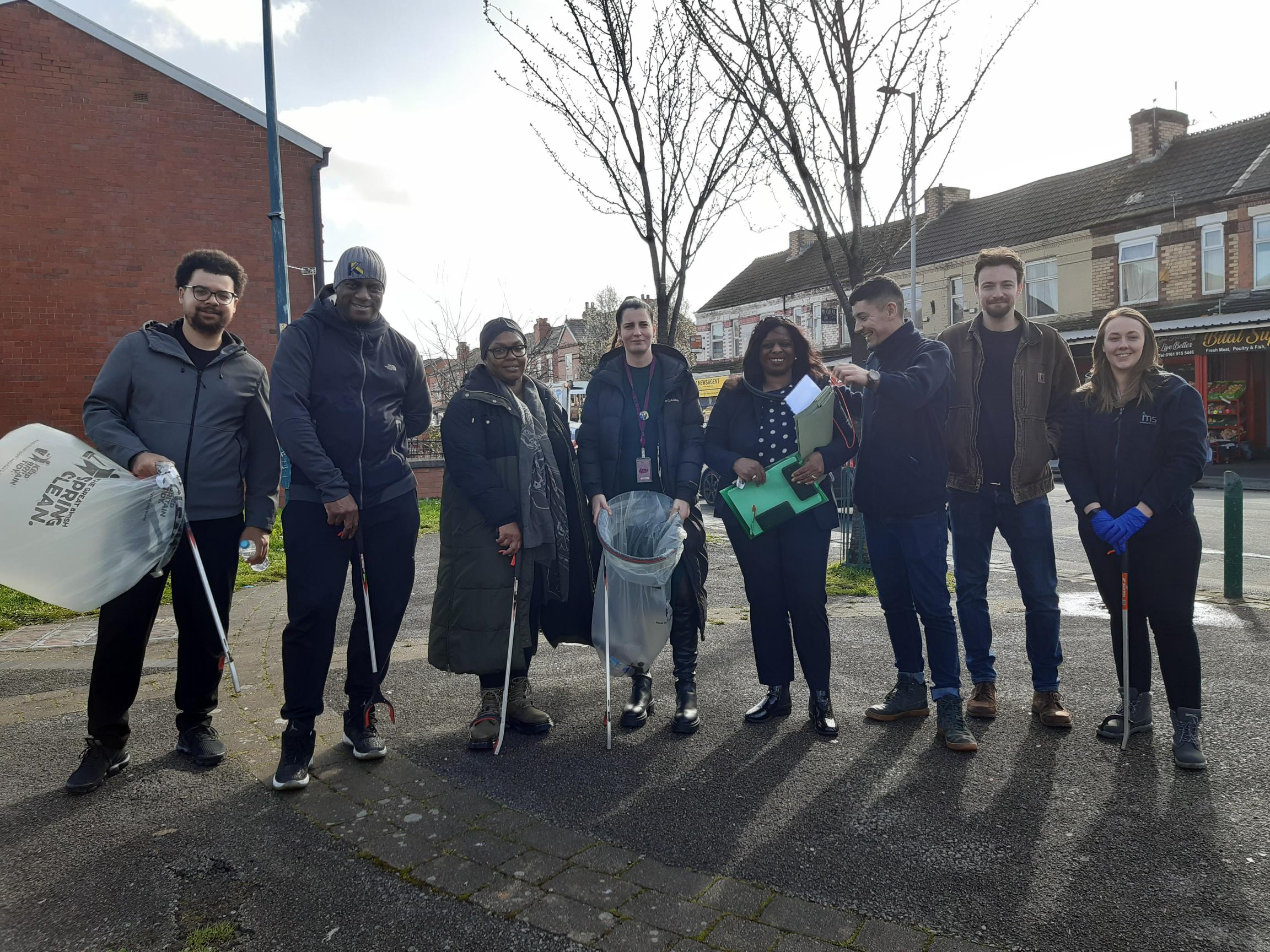 Moss Side residents meet up for spring clean holding bags and litter pickers