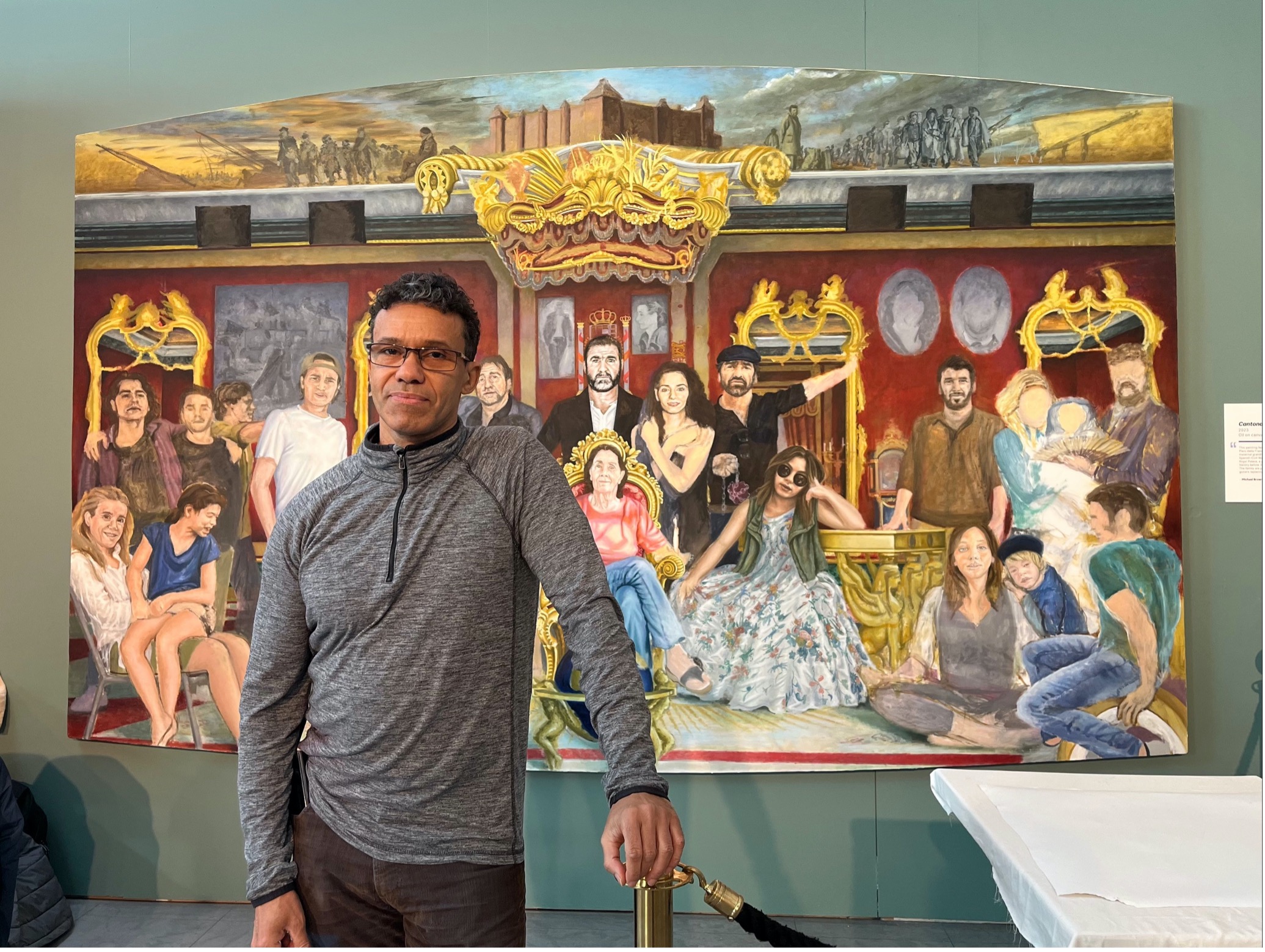 Michael Browne in front of painting of Eric Cantana and his family - National Football Museum