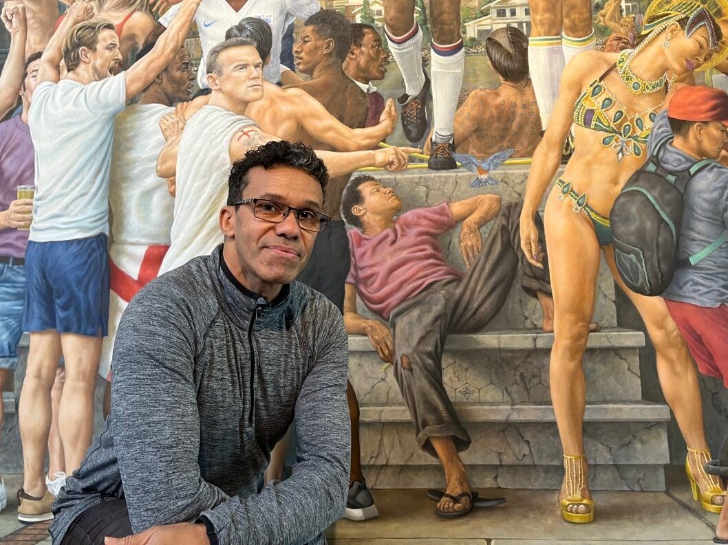 Michael Browne in front of his painting which features him