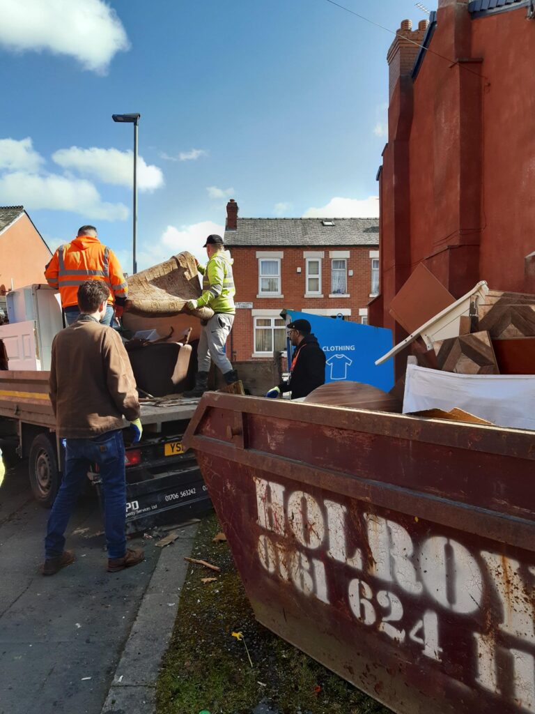 Men loading large items onto a van.