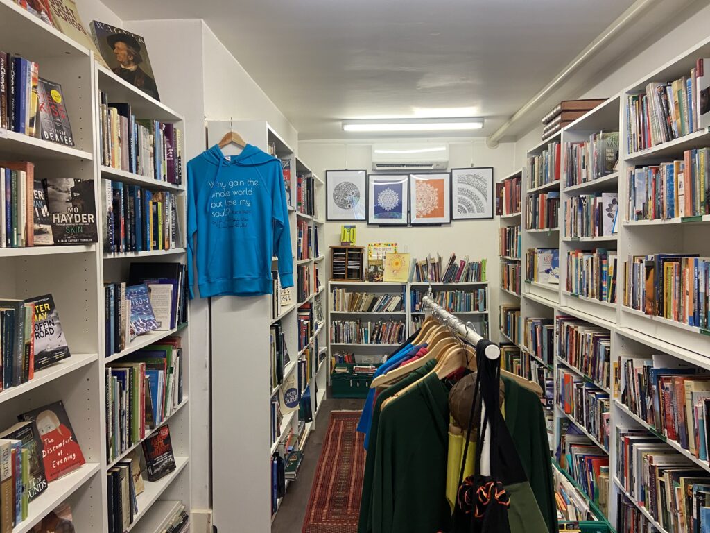 Photo of inside Alexandria Library showing full bookcases and clothing.