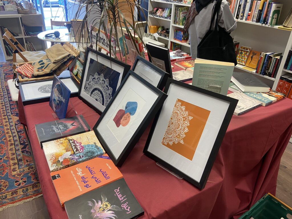 Framed artwork and books on sale inside Alexandria Library.