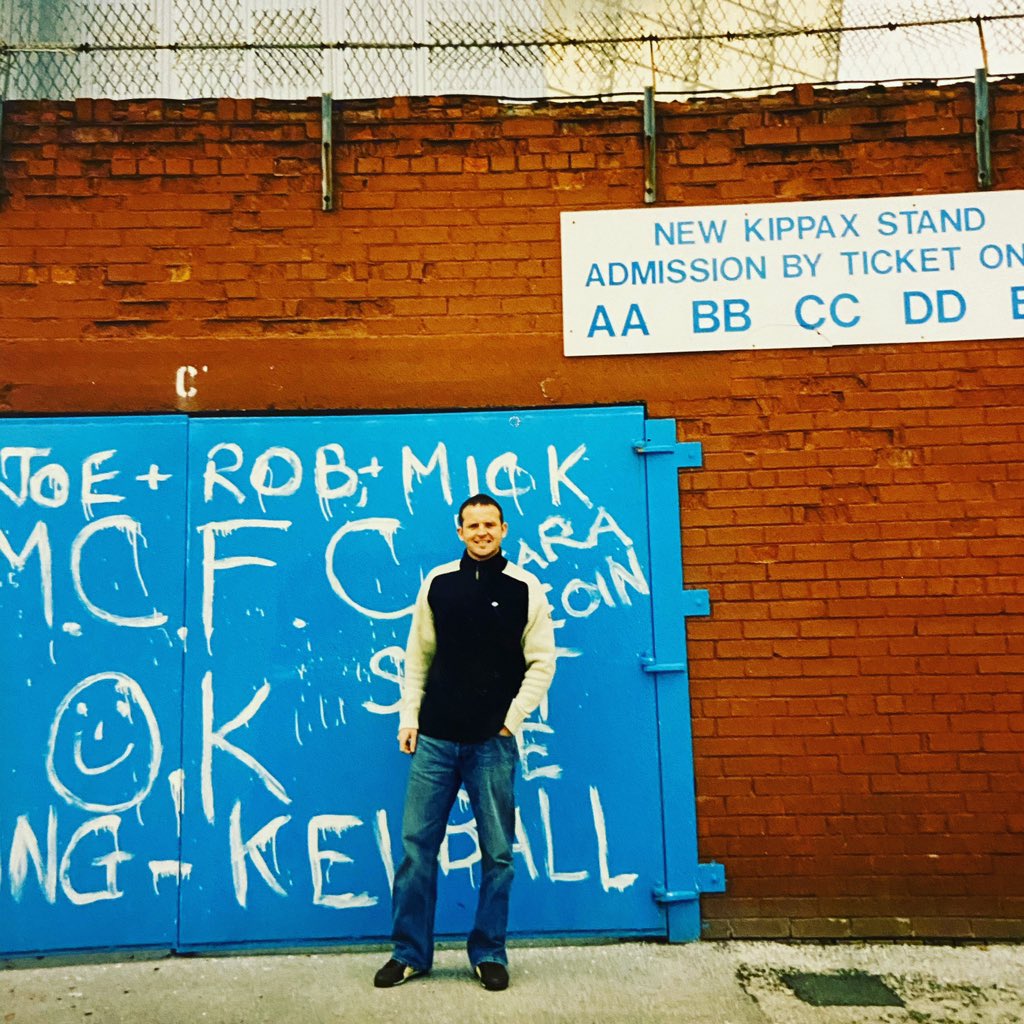 Man stood in front of Maine Road football stadium.