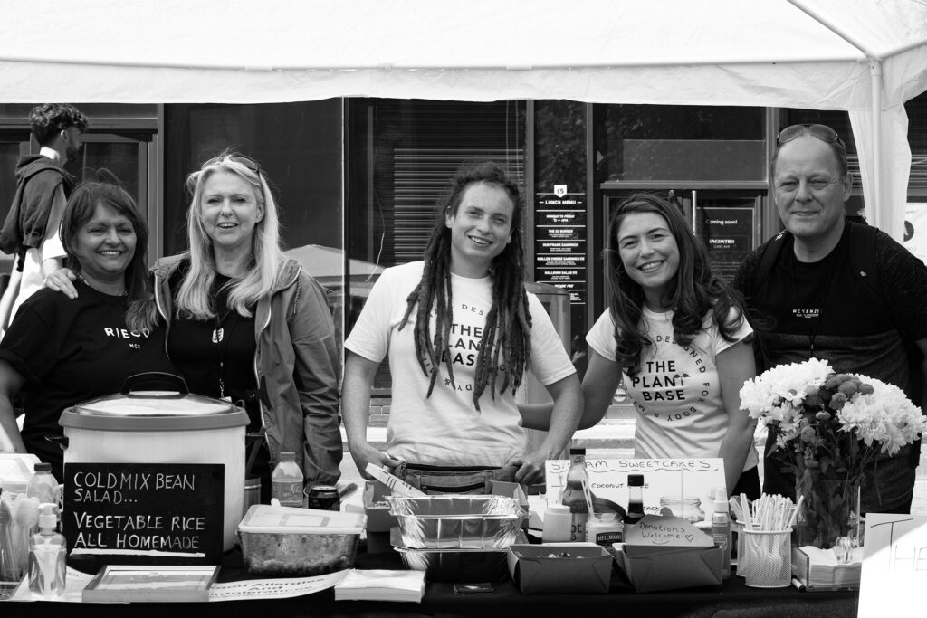 A group of people at a fundraising event selling food items