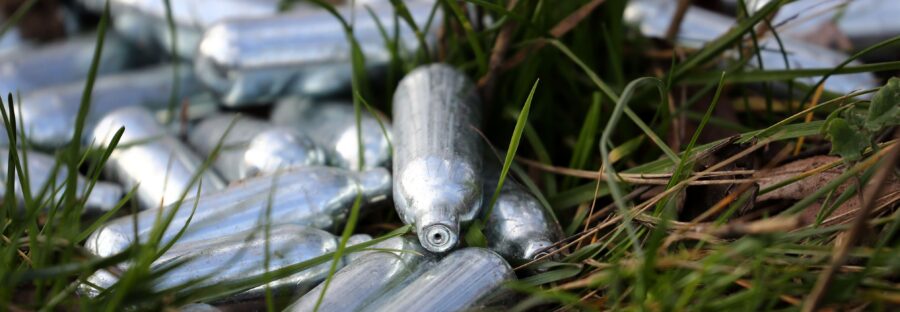 Laughing gas canisters discarded by the side of a road near Ebbsfleet, Kent