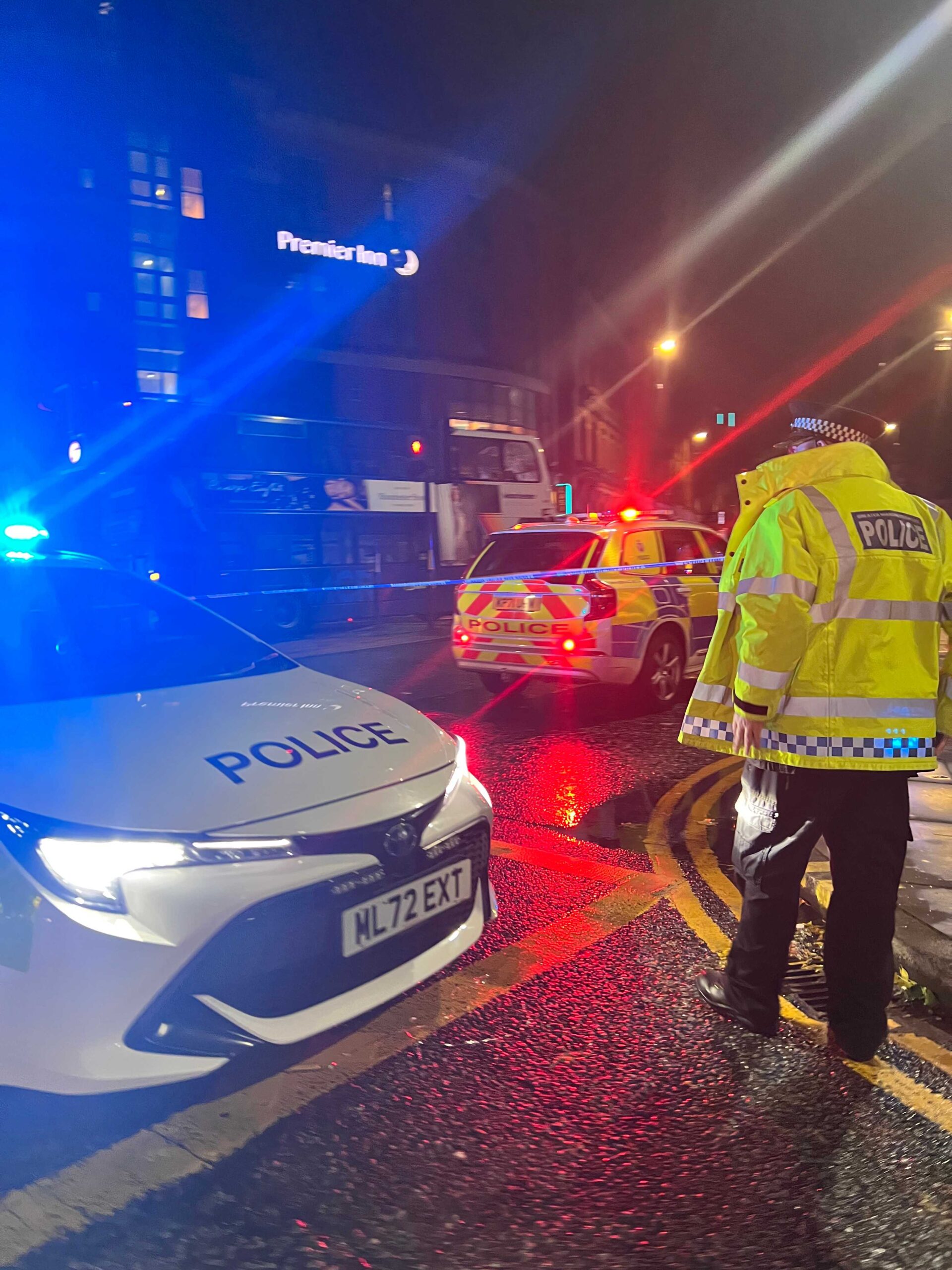 Police cars swarmed Manchester city centre after two men were knocked down by two buses.