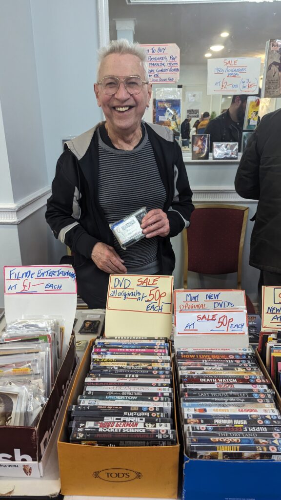 Philip Nevitt proudly displaying his lifetime Bafta member card whilst manning his stall at Manchester comic and sci-fi fair