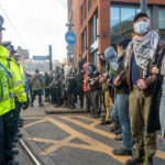 Police and counter protestors line up