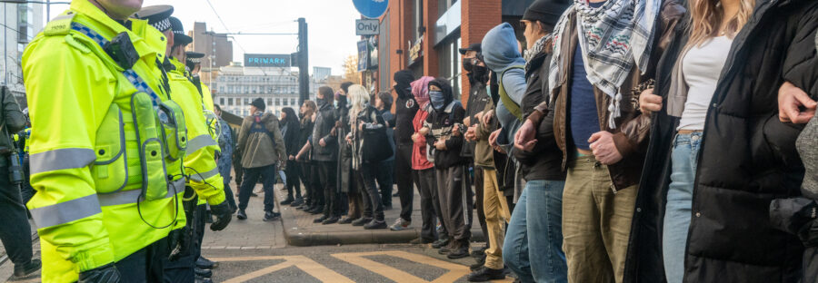 Police and counter protestors line up