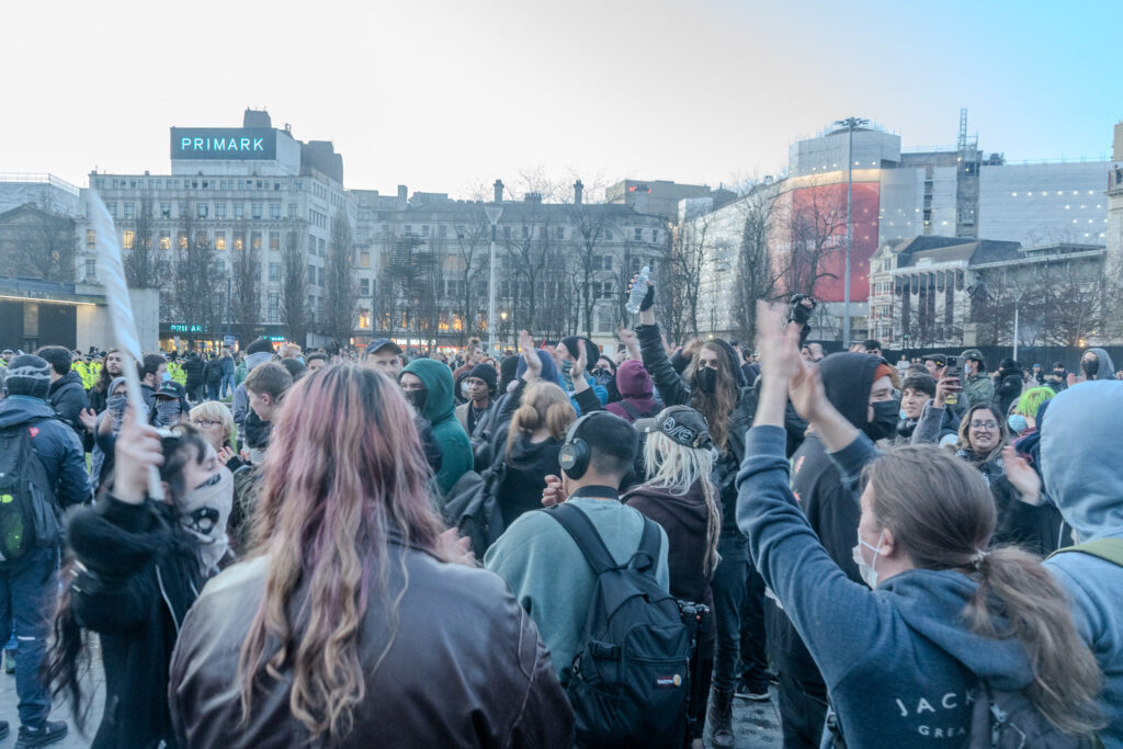 A crowd of people in Picadilly Gardens.