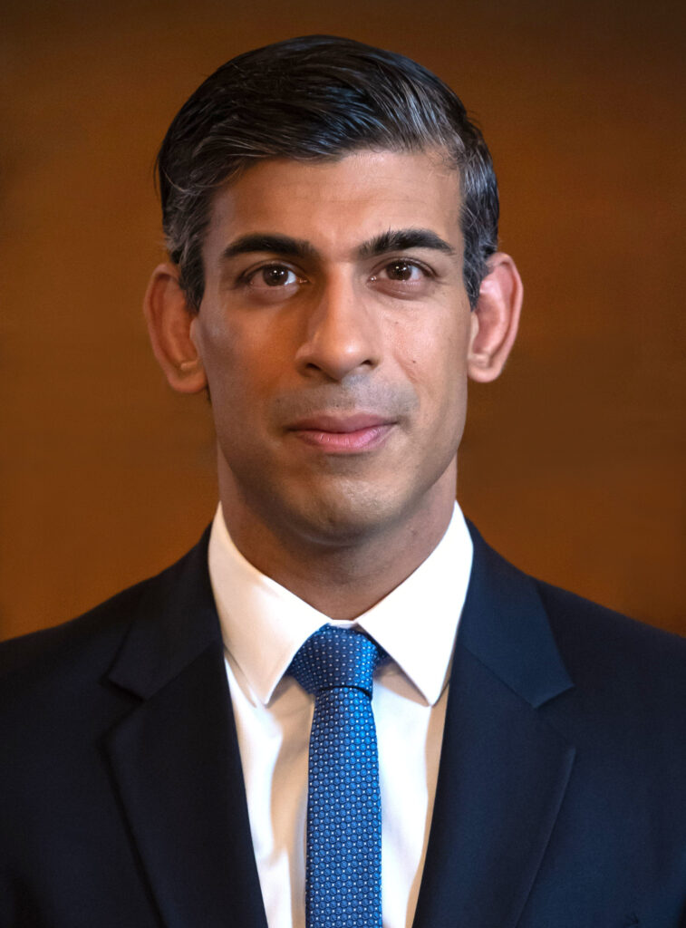 Let image: Andrew Tate, a bald man with a beard wearing a grey shirt. He is looking past the camera. 

Right image: Rishi Sunak, a brown man with short black hair looking directly into the camera and wearing a suit. 