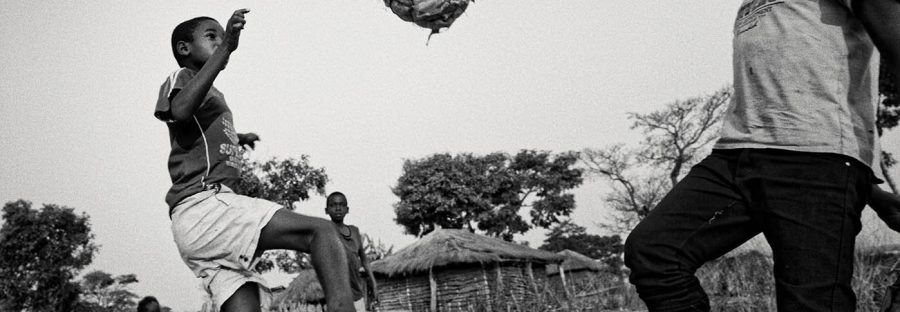 Two boys play football on a former minefield, which was cleared by MAG (Sean Sutton/MAG)