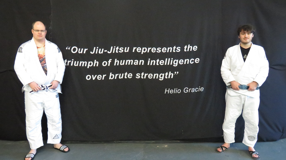 philip_left_and_james_right_at_the_centre_in_front_of_a_quote_from_the_founder_of_gracie_jiu_jitsu_displayed_inside_the_gracie_jiu_jitsu_tameside_centre