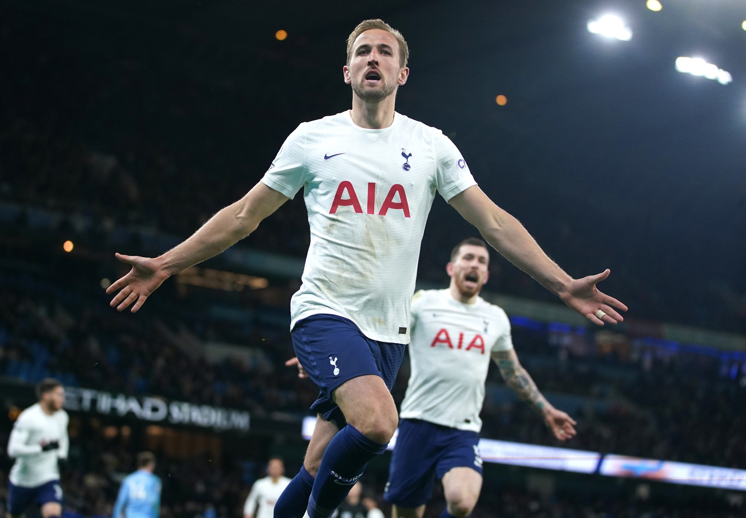 Harry Kane Celebrating after his last minute winner with his arms out.