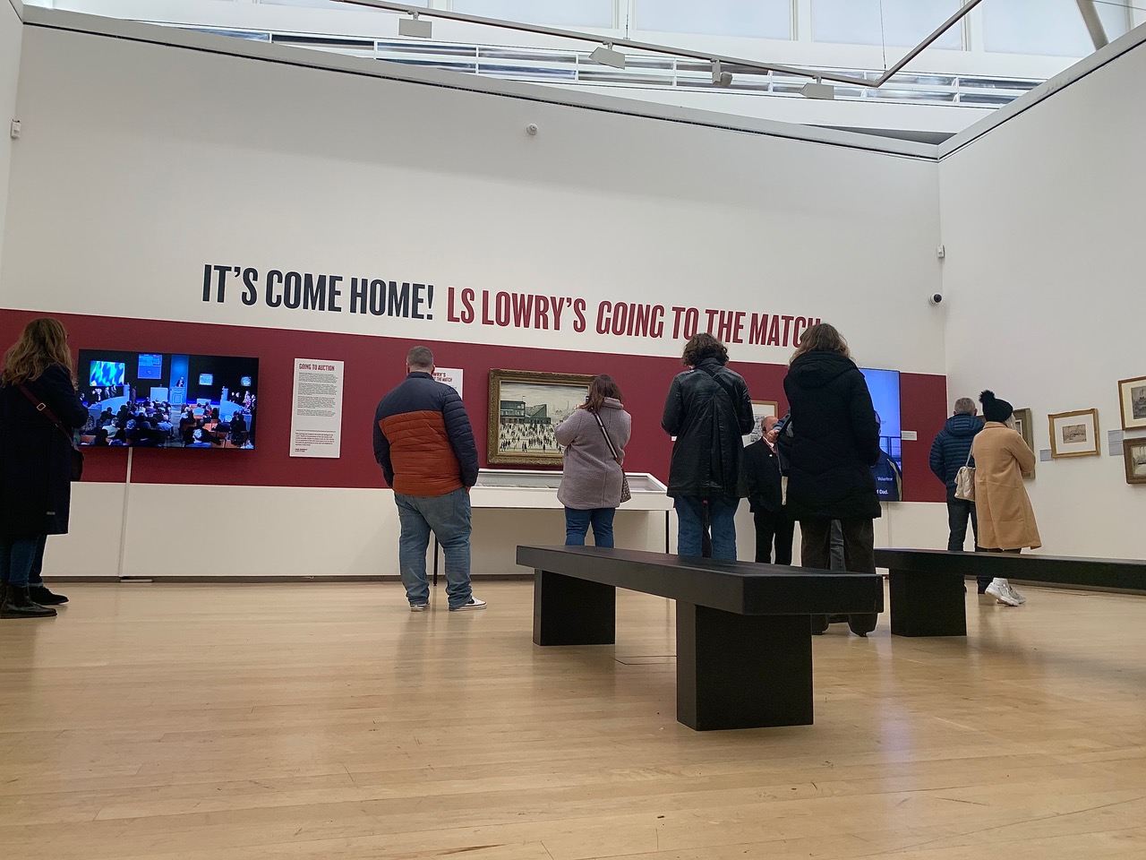 People viewing 'Going to the Match' painting