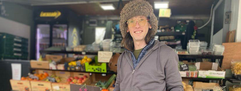 Stallholder Daniel Smith holds up a bunch of red tomatoes