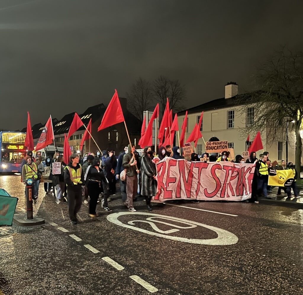 Student waving placards and banners march down Wilmslow Road in March 2023.