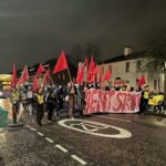 Student waving placards and banners march down Wilmslow Road
