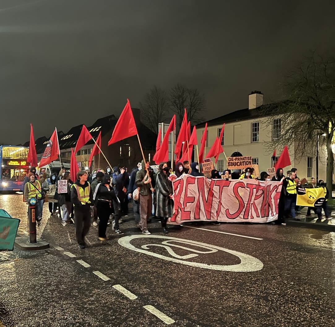 Student waving placards and banners march down Wilmslow Road