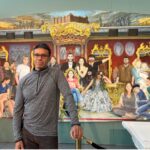 Michael Browne in front of painting of Eric Cantana and his family - National Football Museum