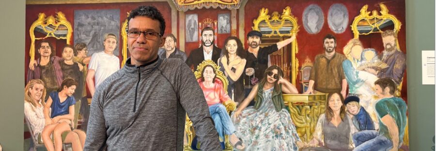 Michael Browne in front of painting of Eric Cantana and his family - National Football Museum