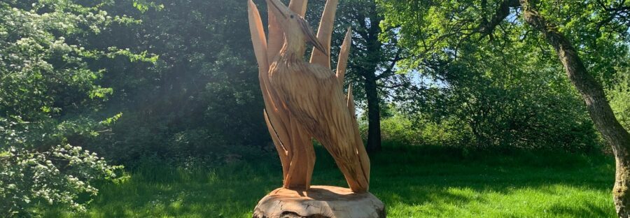 A wood carving of a heron in Boggart Hole Clough