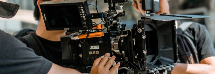 three men behind the camera filming - pexels.com