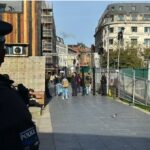 metal arches in Piccadilly Gardens, guarded by GMP