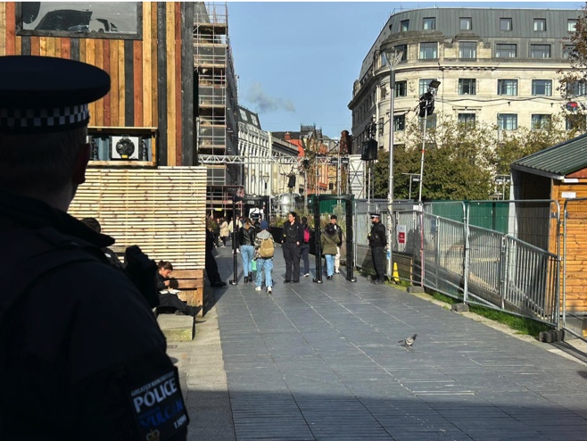 metal arches in Piccadilly Gardens, guarded by GMP