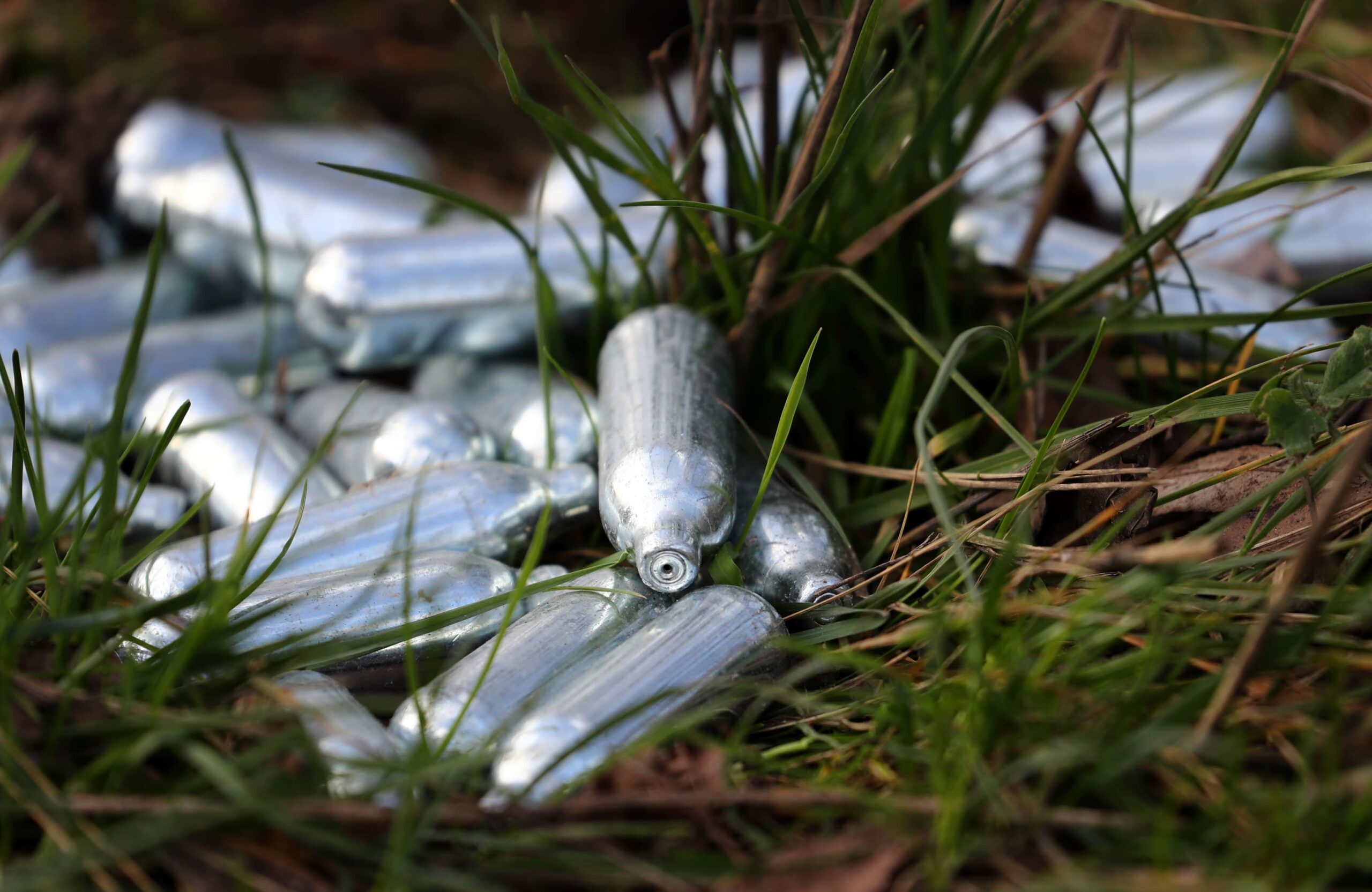 Laughing gas canisters discarded by the side of a road near Ebbsfleet, Kent