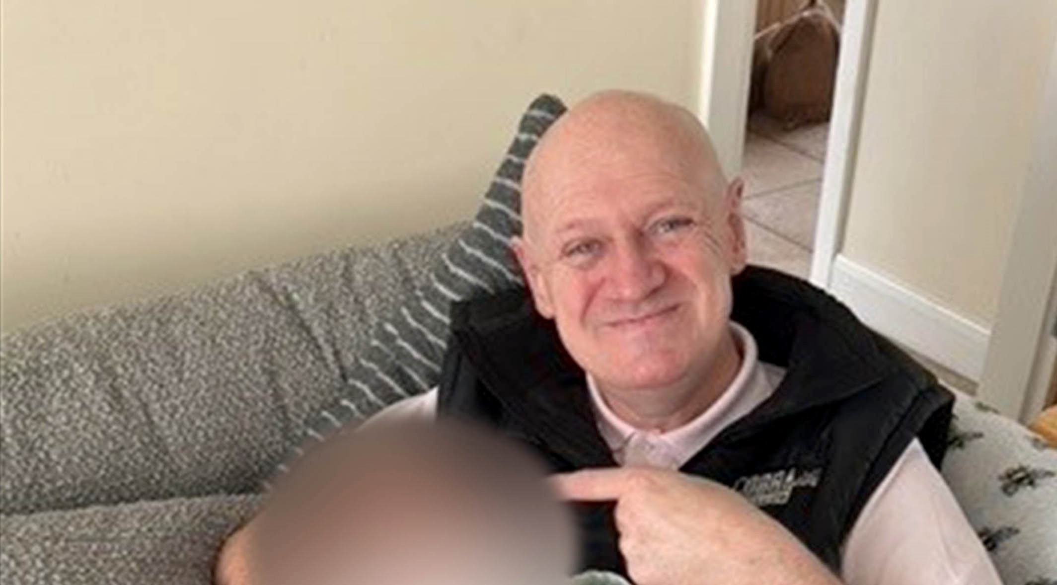 Murder victim, Chris Hanley, holding baby