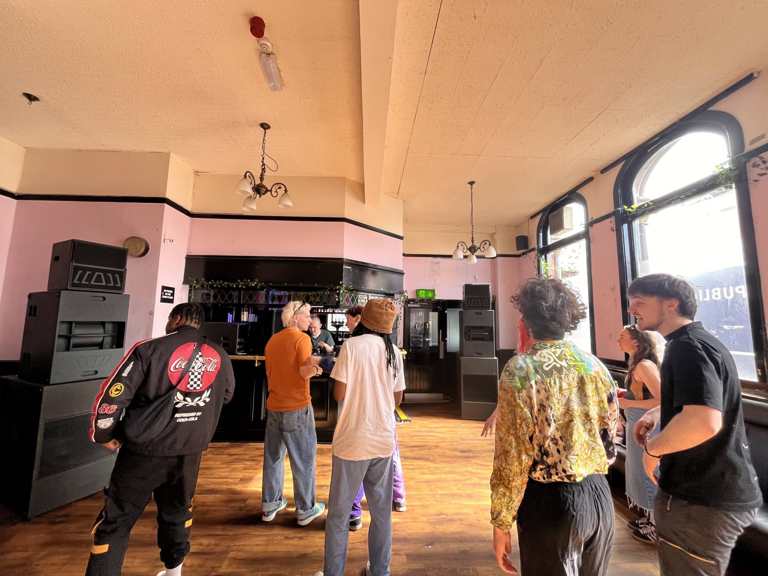 People dancing in DBA events space with colour lights and music.