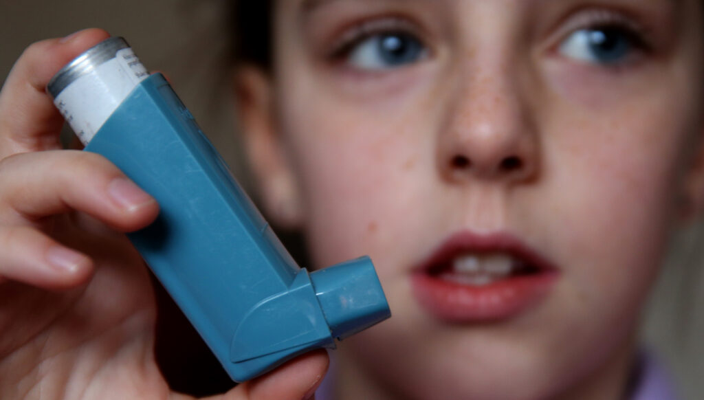 Child with blue inhaler