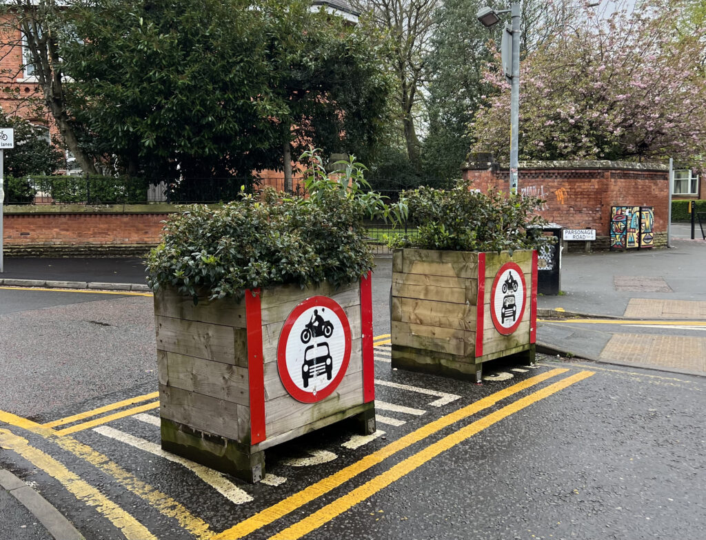 Low traffic neighbourhood planters in middle of Parsonage Road, blocking cars from entering road.