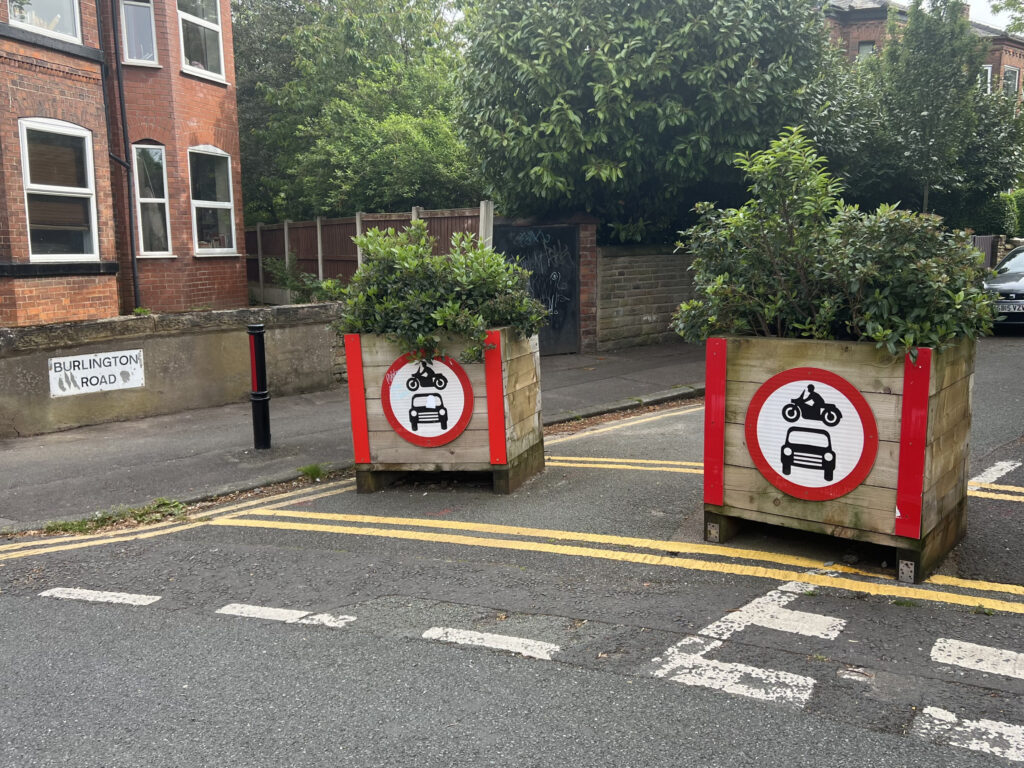 Low traffic neighbourhood planters in middle of Burlington Road, blocking cars from entering road.