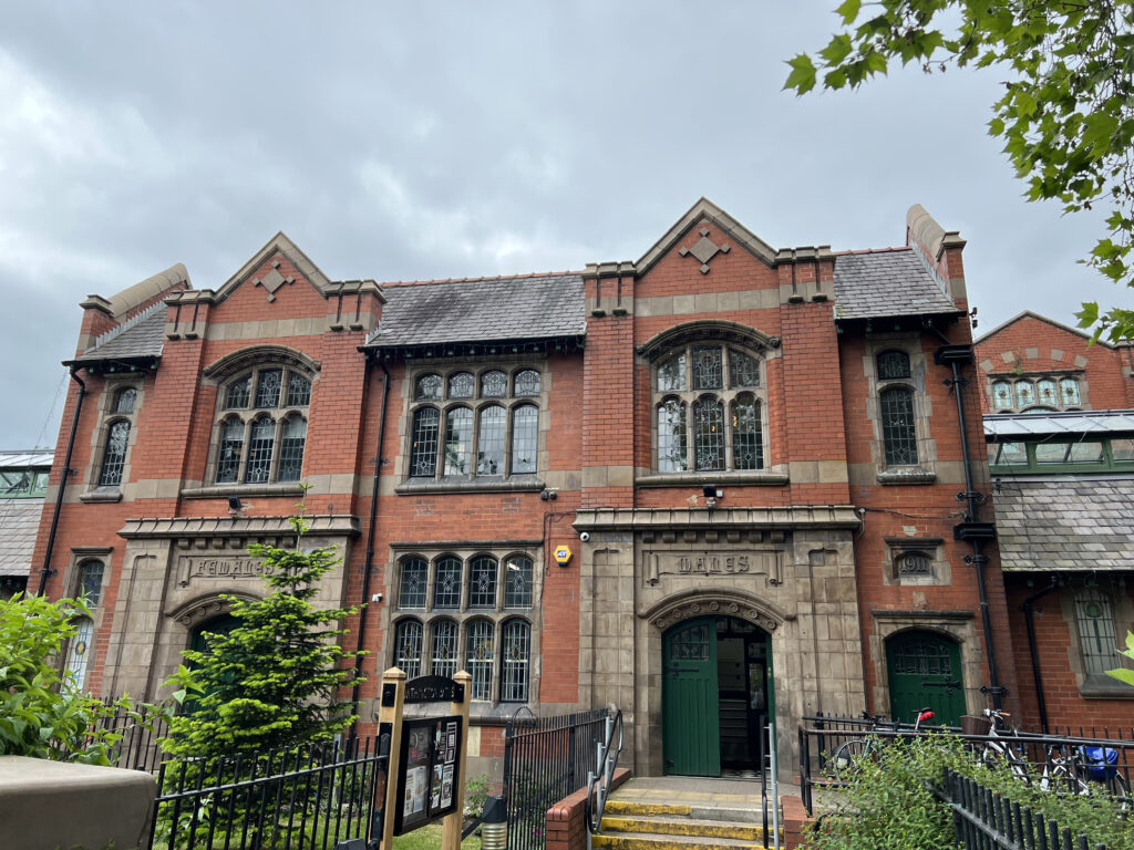 Outside Withington Baths entrance, with its original arches still in tact.