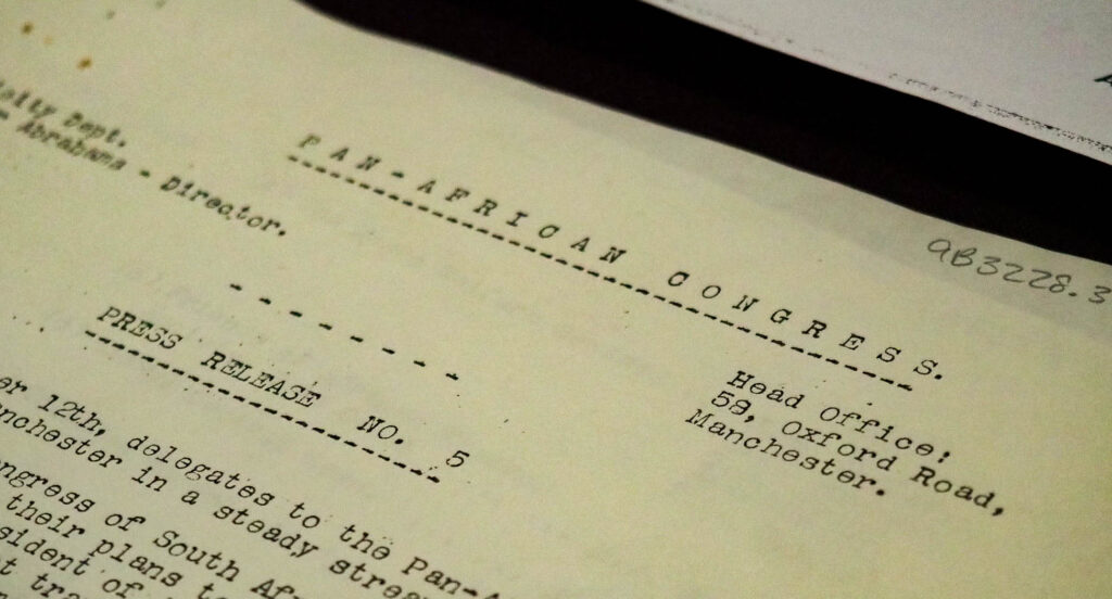 A close-up of a faded typewritten document. The visible words read: "PAN-AFRICAN CONGRESS / Head Office: 58, Oxford Road, Manchester. / PRESS RELEASE NO.5"