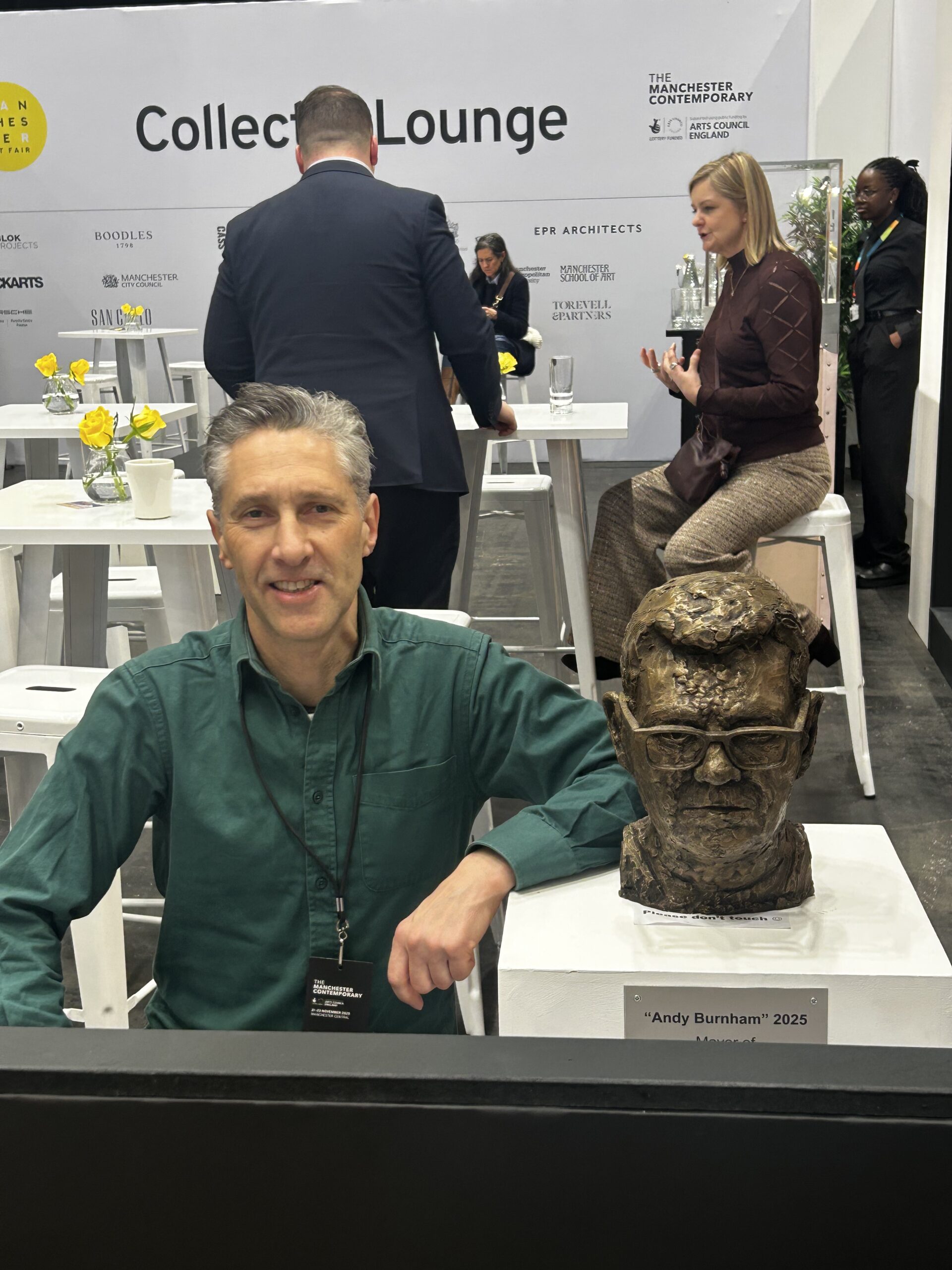 Artist Anthony David Padgett poses alongside his bronze sculpture of Andy Burnham