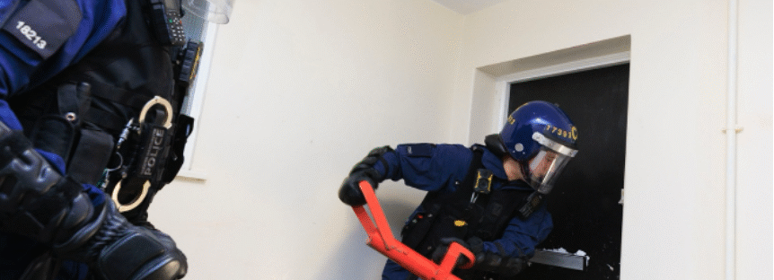 police officers breaking house in brinnington