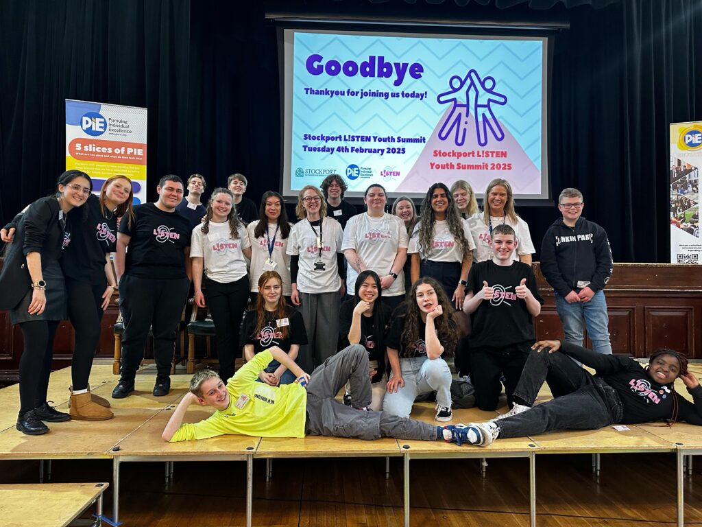 A group of people stood on a stage smiling