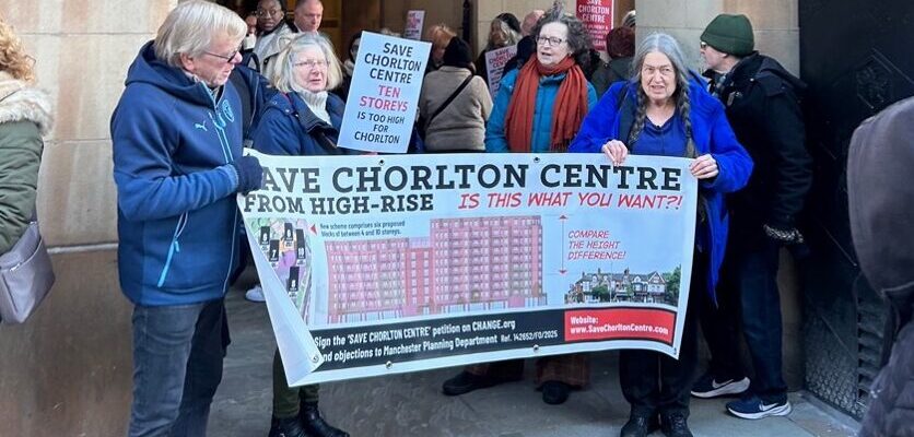 A group of people holding a campaign poster