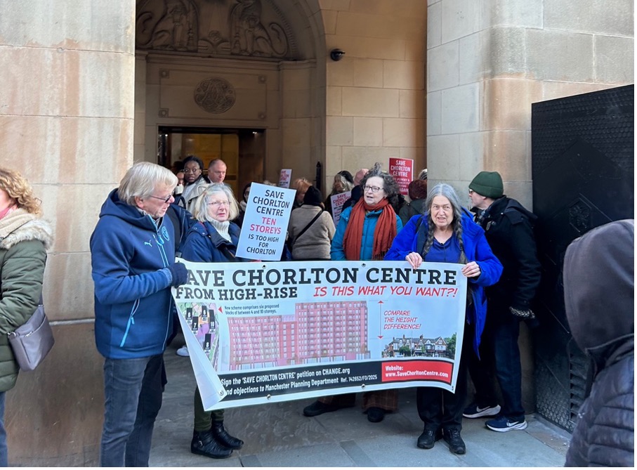 A group of people holding a campaign poster