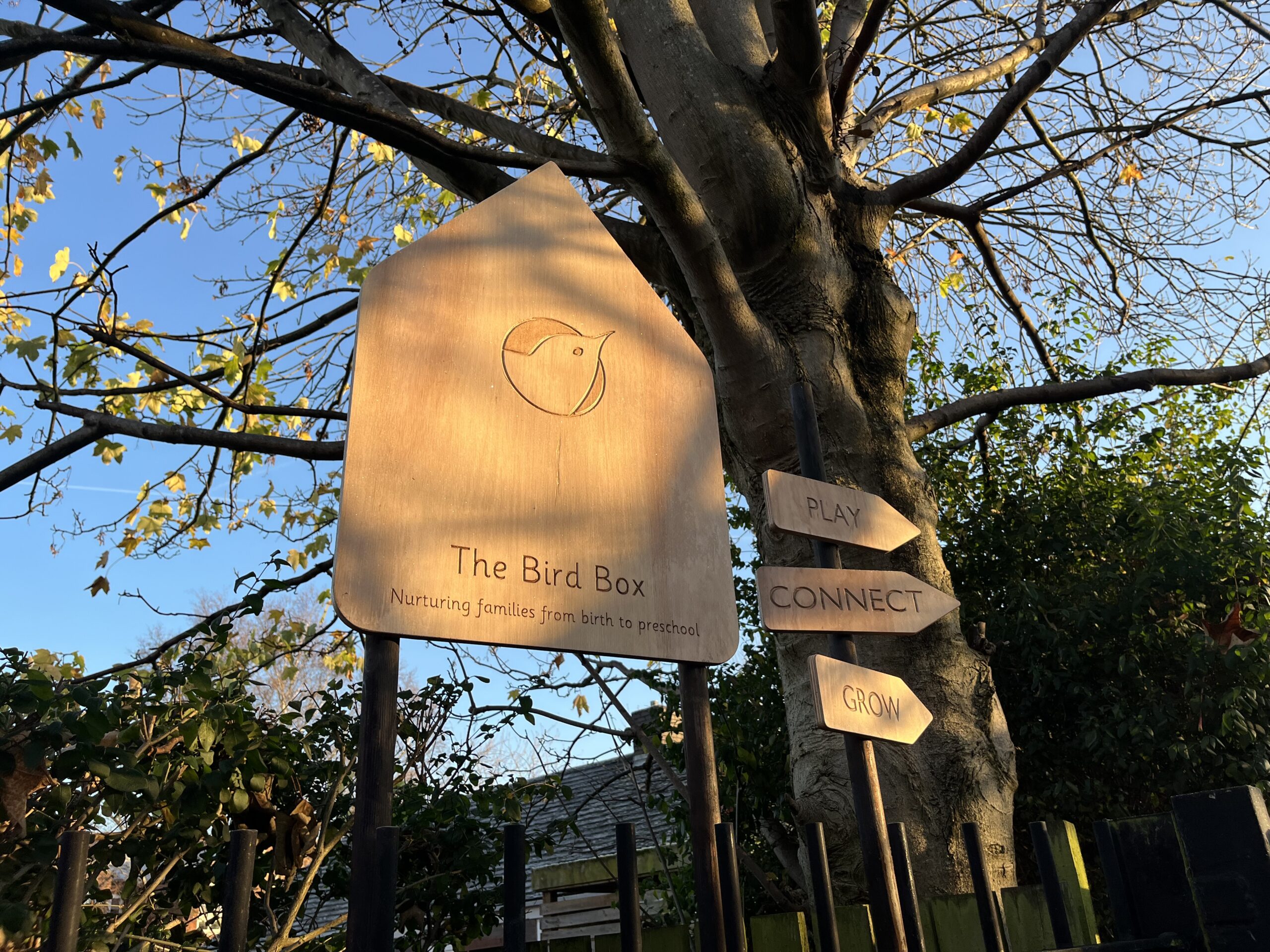 Image of signs with tree behind