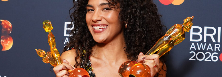 Olivia Dean with her four Brit Award